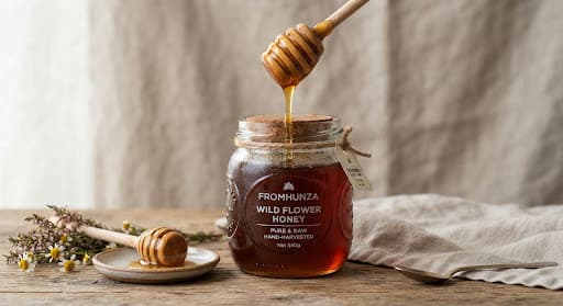 Honey jar with a wooden dipper